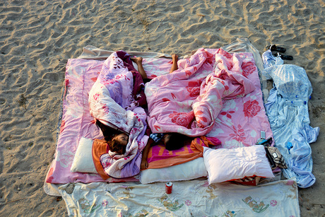 Children sleeping on the beach.