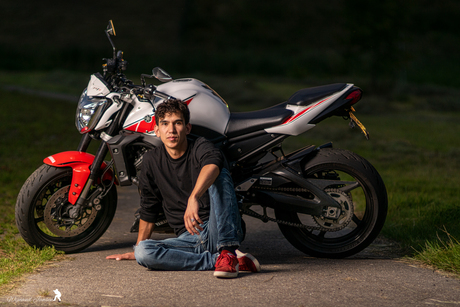 Relaxed in front of his motorcycle