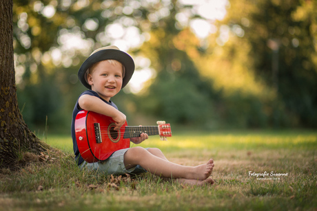 Playing the guitar just like his grandpa!