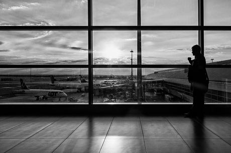 man waithing on his plane looking at the sunset