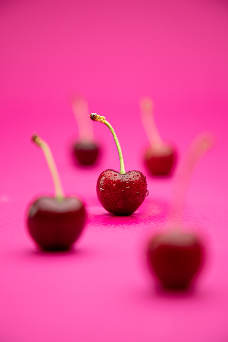 Wet cherry in focus.
