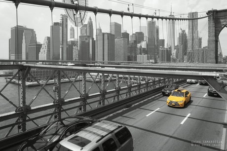 Yellow taxi on Brooklyn bridge