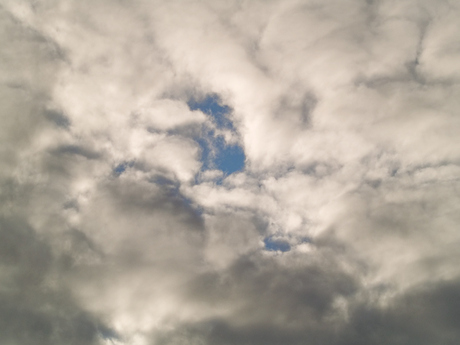 De blauwe verte tussen de wolken