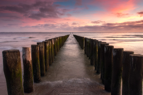 Breakwaters on a beach during Sunset