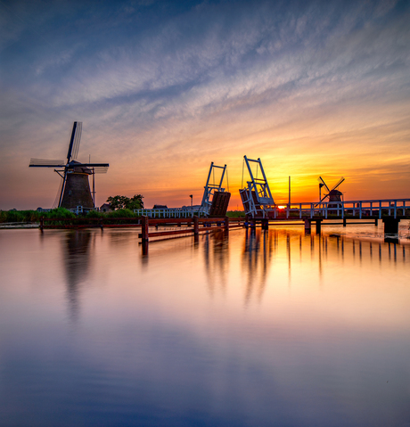 Windmill and drawbridge at sunset