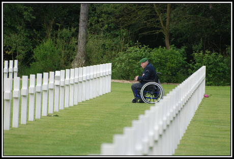 Een oorlogsveteraan rouwt bij het graf van zijn overleden kameraad.