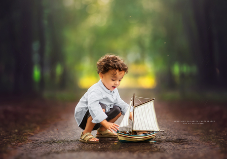 In the rain's gentle embrace, a little boy's dreams set sail.
