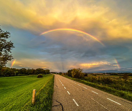 Rainbow above the road ahead