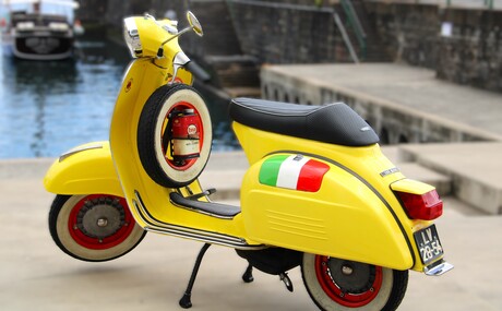 Gele klassieke Vespa scooter.