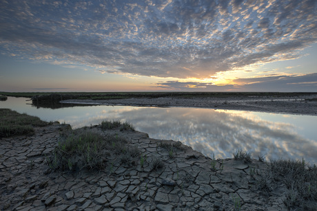 Zonsondergang aan het wad