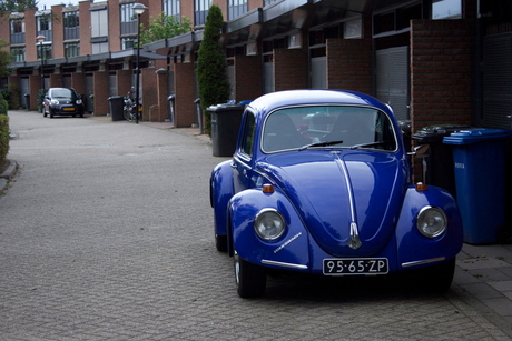 Old blue beetle in Modern street