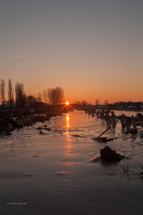 Zonsondergang boven bevroren akker