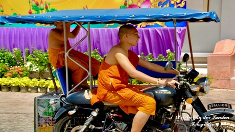 Thai monks riding a moped