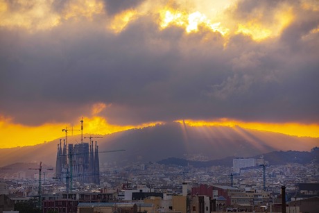 Sun breaking through clouds from a Barcelona roof top view