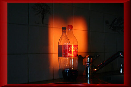 Cola fles in ochtendzon