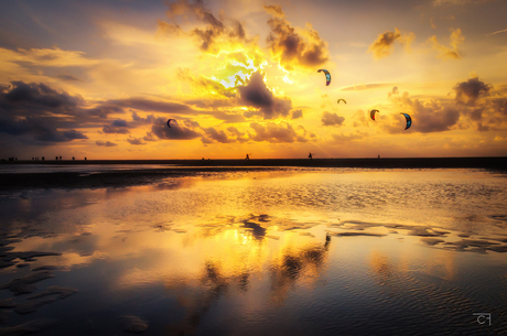 Avondsessie kitesurfen met ondergaande zon