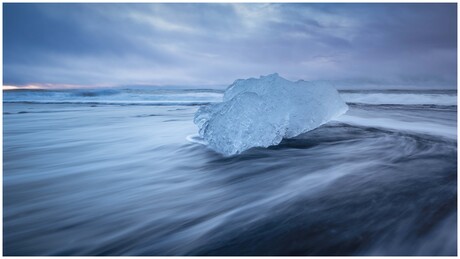 A massive chunk of ice in the crashing waves
