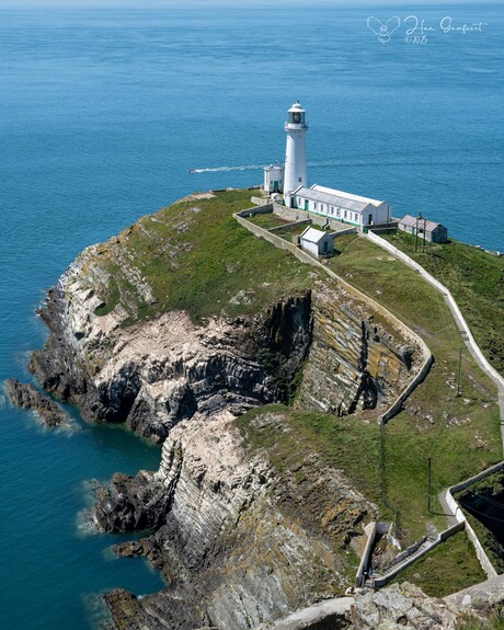 At the edge of the ocean. 