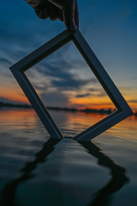 Sunset above the water with a frame 