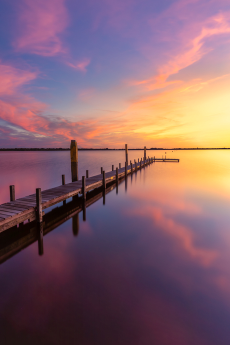 kleurrijke long exposure - Steiger met zonsondergang