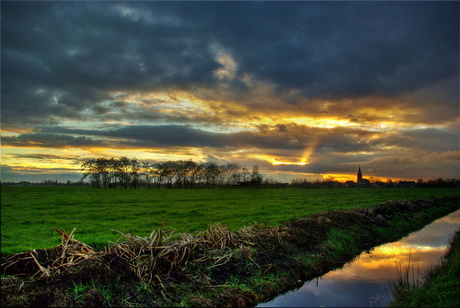 zon door de wolken