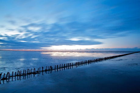 Het wad bij Ternaard bij zonsondergang