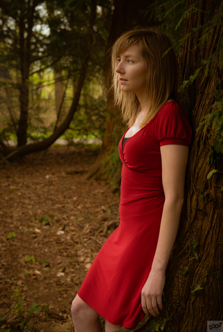 Wearing red in a green forest