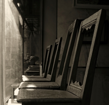 we have become empty spectators on old chairs behind a vintage window