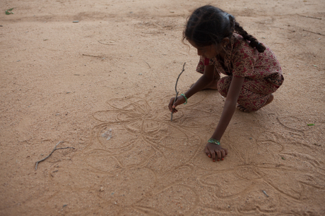 Child drawing in sand, India.jpg
