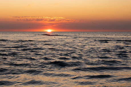 Zonsondergang aan zee