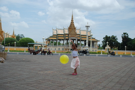 A little girl playing with a balloon