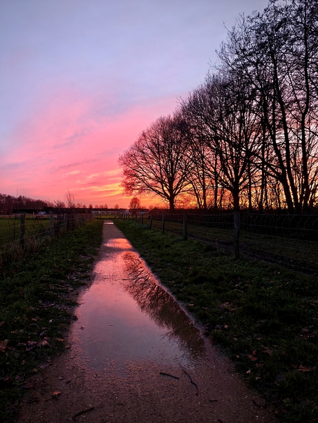 Zonsondergang met regenplassen 
