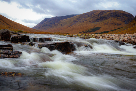 Mountain river flowing through the Scottish Highlands – autumn tones & rugged valley