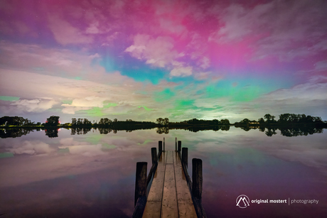 Northern Lights dancing above still waters...