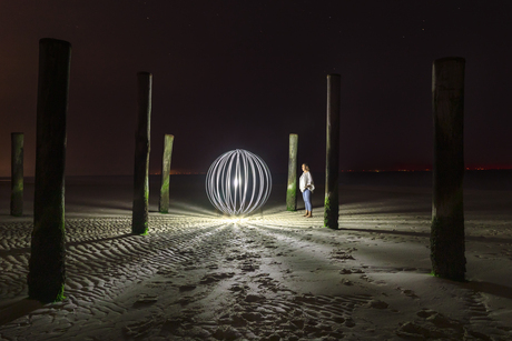 Lightbol tussen de palen op het strand in Petten